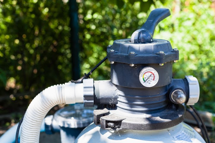 water pump of outdoor filtering system of swimming pool in summer day